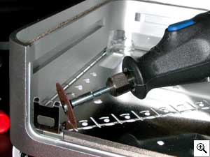 Cut the metal anchor for the security slot off before putting the
cover back on. Cut it flush with the Mini's casing.