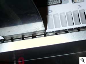 Put your putty knife into the back of the Mini to help you nudge the
shielding inside the cover when you are snapping it back together.